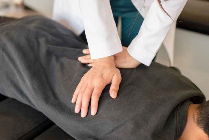 Chiropractor performing a spinal adjustment as part of wellness services in Lansing to help patients improve mobility and reduce pain.