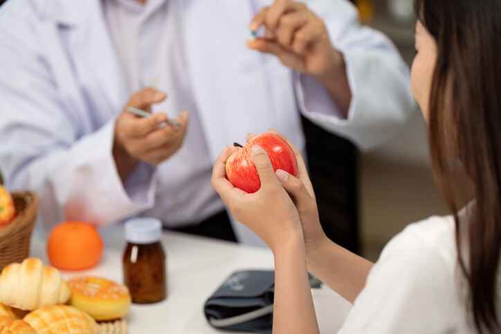 Nutritionist providing a nutrition consultation, demonstrating healthy food choices during an appointment in Lansing MI